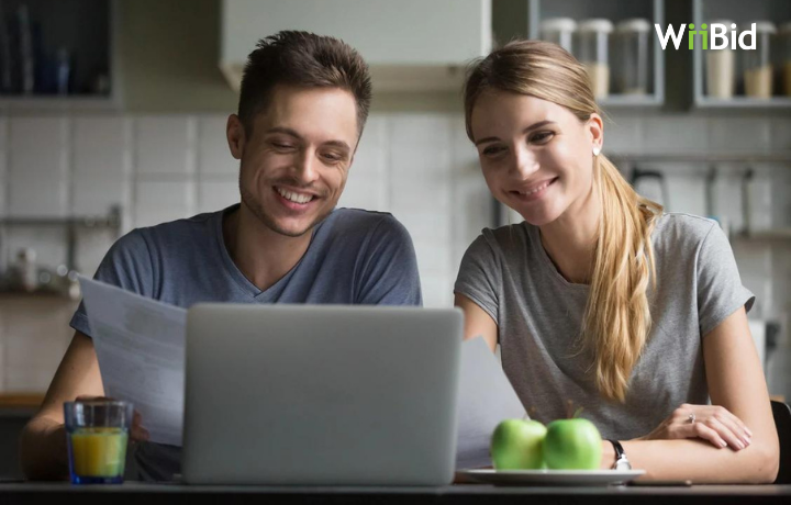 two couple looking on their computer screen for mortgage